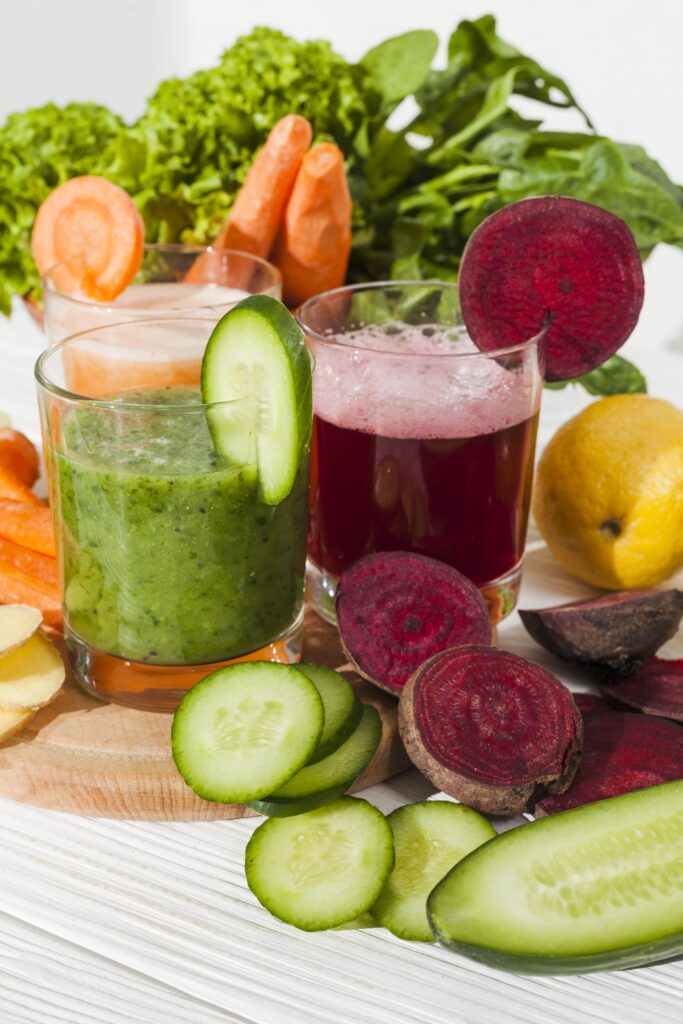 Fresh vegetable juices made from cucumber, beetroot, carrot, and leafy greens, illustrating high-fiber whole food sources discussed in fibromaxxing health debates.